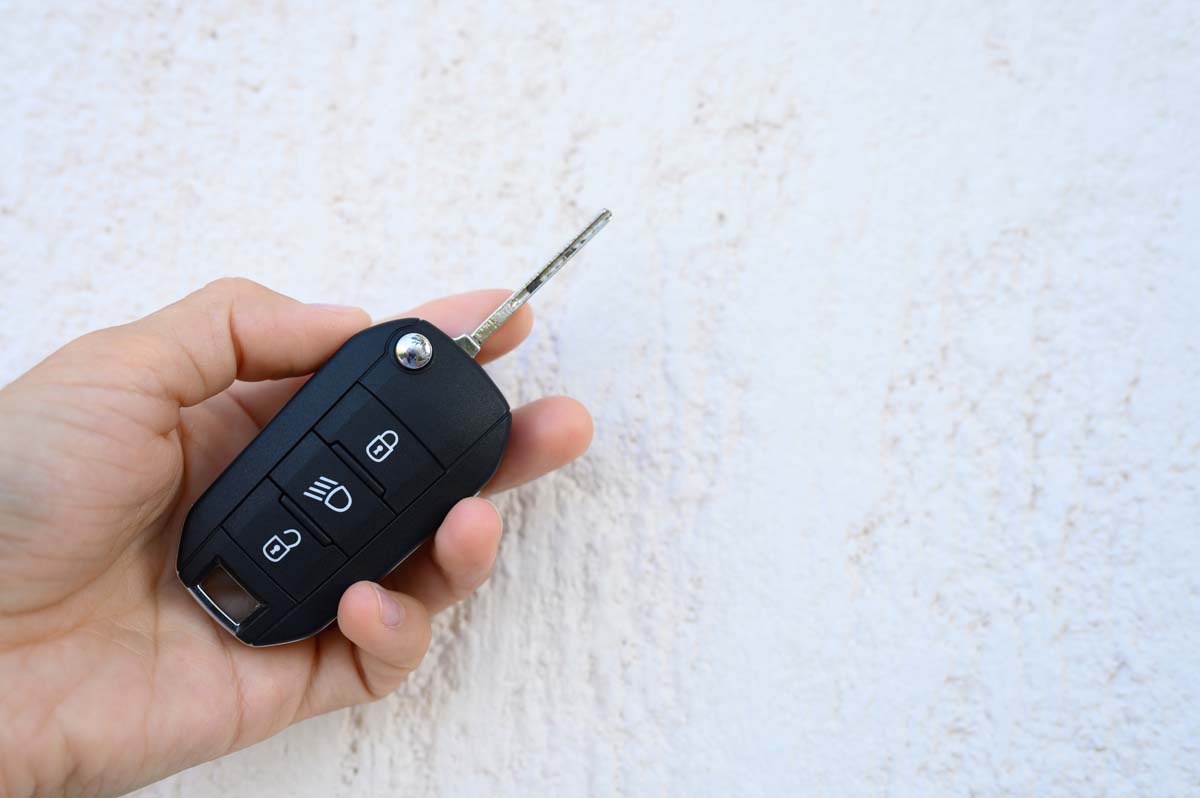 Car Key With Remote Control In Female Hand On Whit 2022 11 14 00 56 53 Utc 